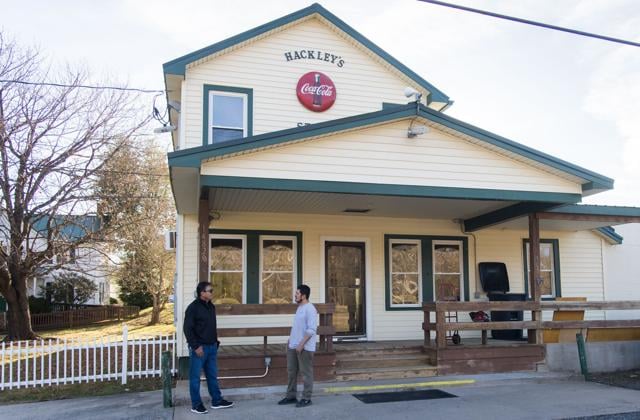 Ernesto Elias, right, in front of the historic Hackley's Country Store in January 2023.