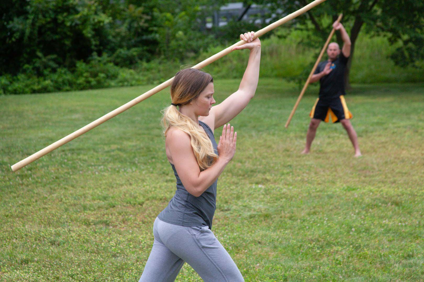Tracie Harron and Gordon Wicks performing wrist, elbow and shoulder conditioning exercises with a Shaolin staff.