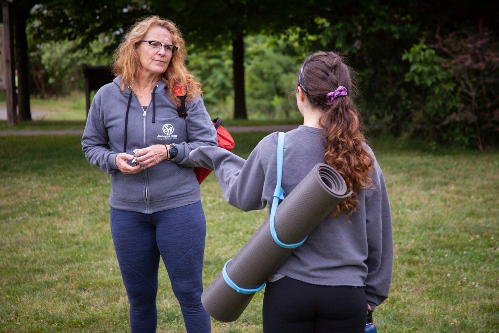 Susan Huff chats with student, Madison Kohler, after outdoor yoga class in Sperryville.