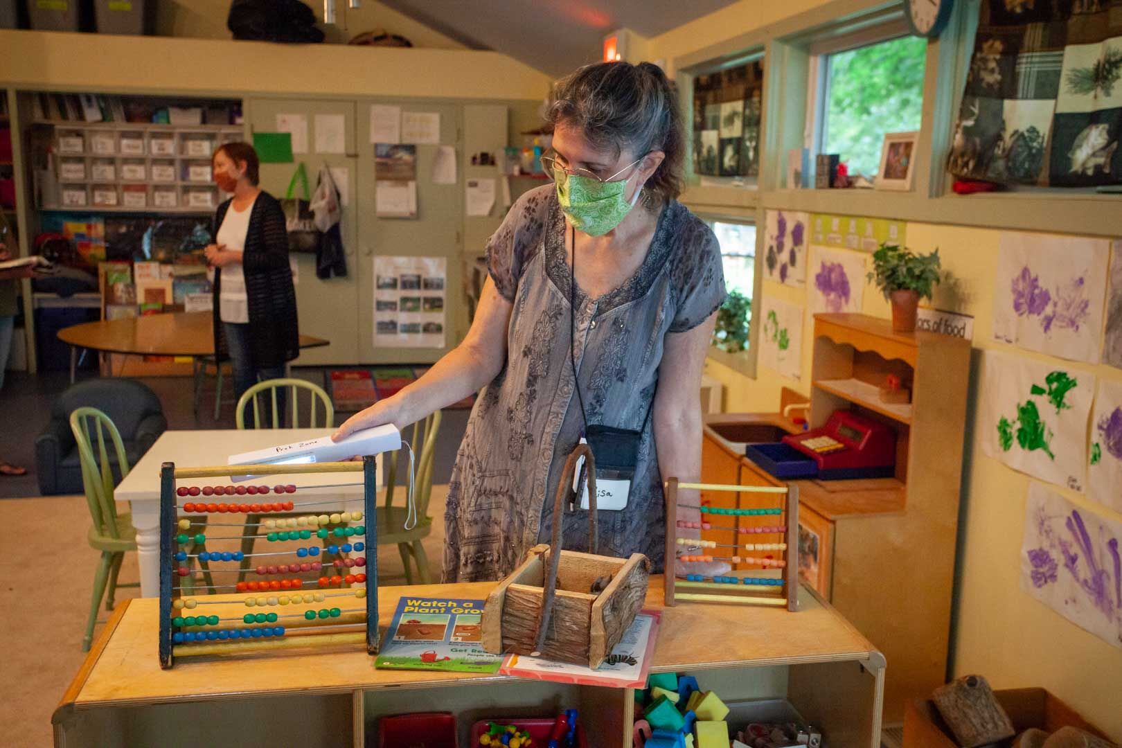 Program Director, Lisa Pendleton scans a toy with a lamp.