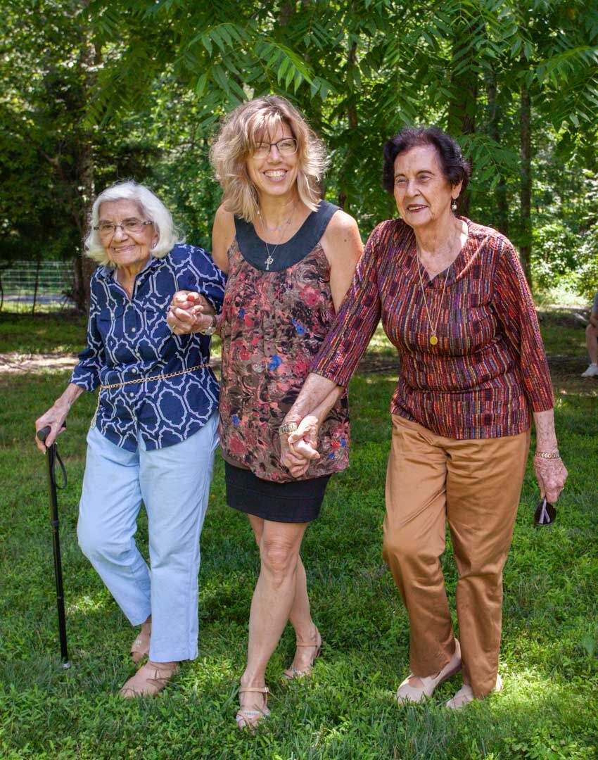 Darcy Canton, Rappahannock Senior Center supervisor, pictured above with Bess Lucking and Frances Thornhill going for a walk this week at the center in Castleton.