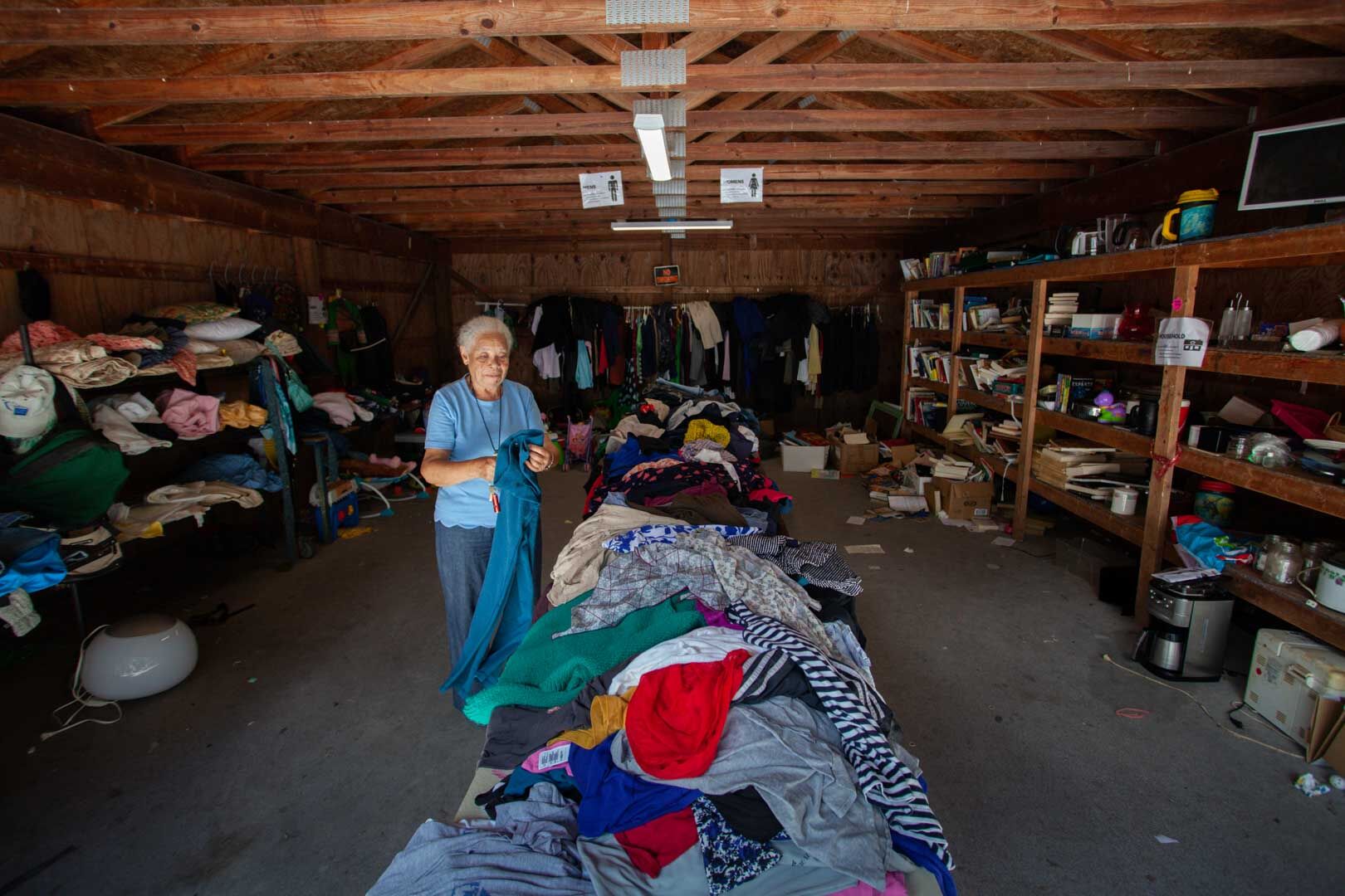 Bessie Grigsby, a Share Shed volunteer, cleaning clutter within the facility.