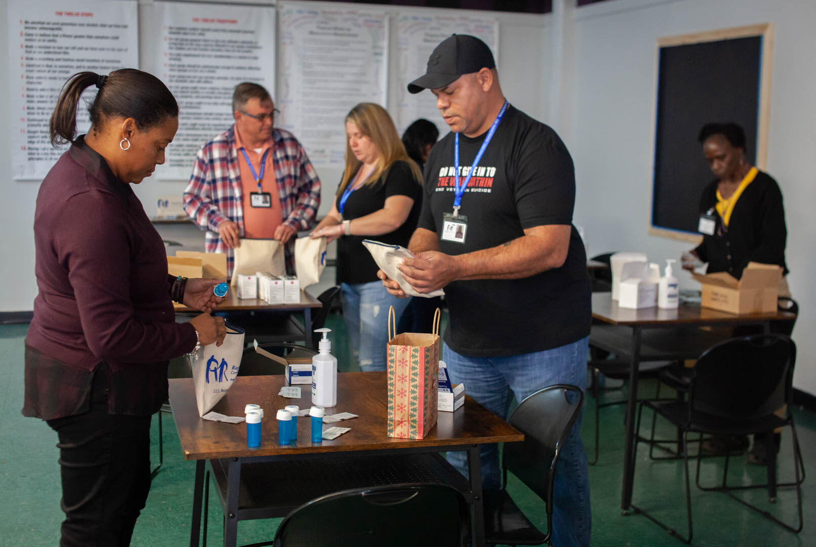Staffers at S.E.E Recovery Center assemble “harm reduction kits” that include NARCAN and fentanyl test strips. “The point is to keep people alive,” said program manager Cory Will.