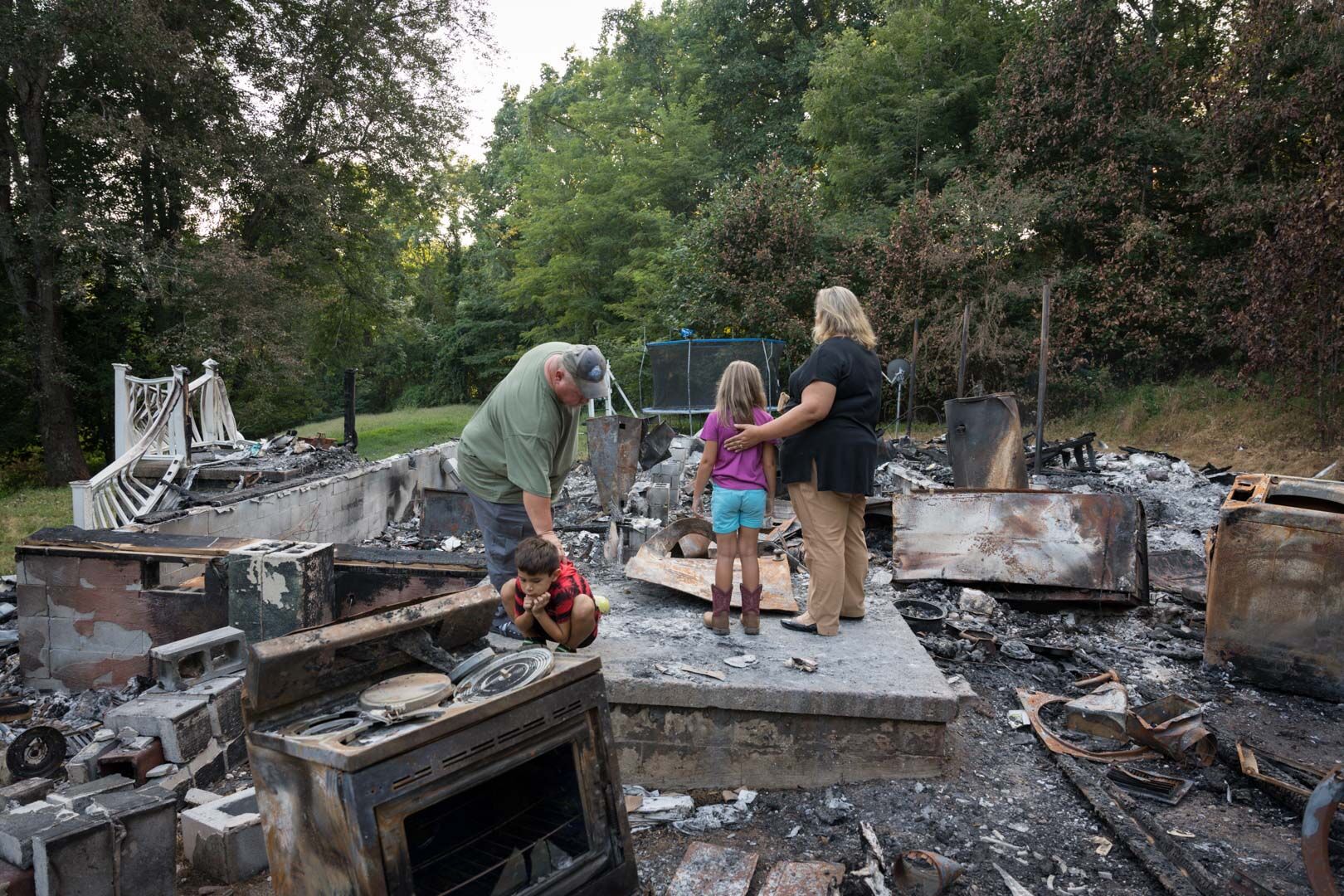 Shortly after a devastating fire last fall, the Ennis family stands in what used to be their home. “I felt like I was at the scene experiencing this family's emotions,” a judge of the Virginia Press Association's annual awards competition wrote, giving photos from the scene a Best in Show honor.