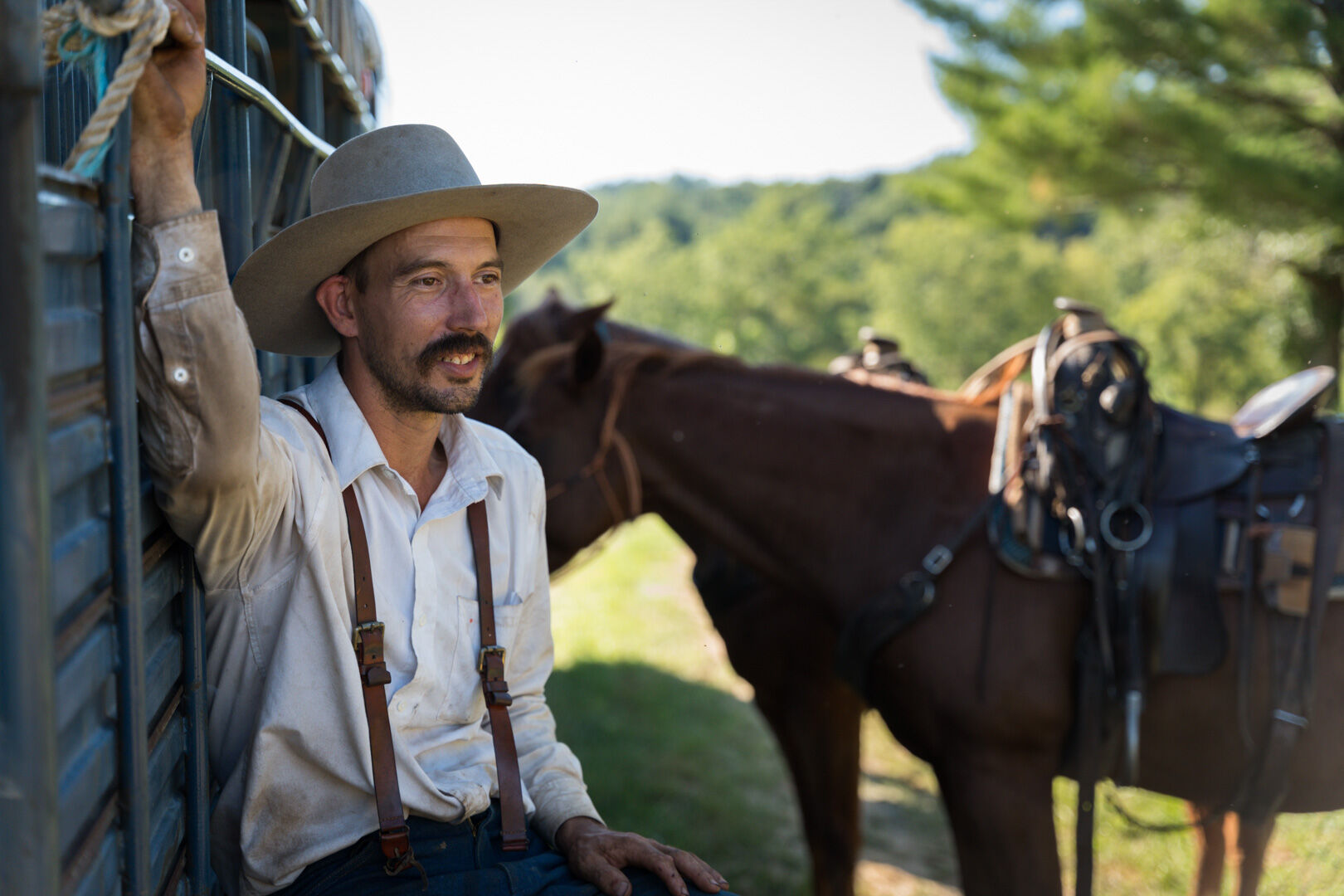 Cattle wrangler Pete Jones takes rest after two rounds of riding.