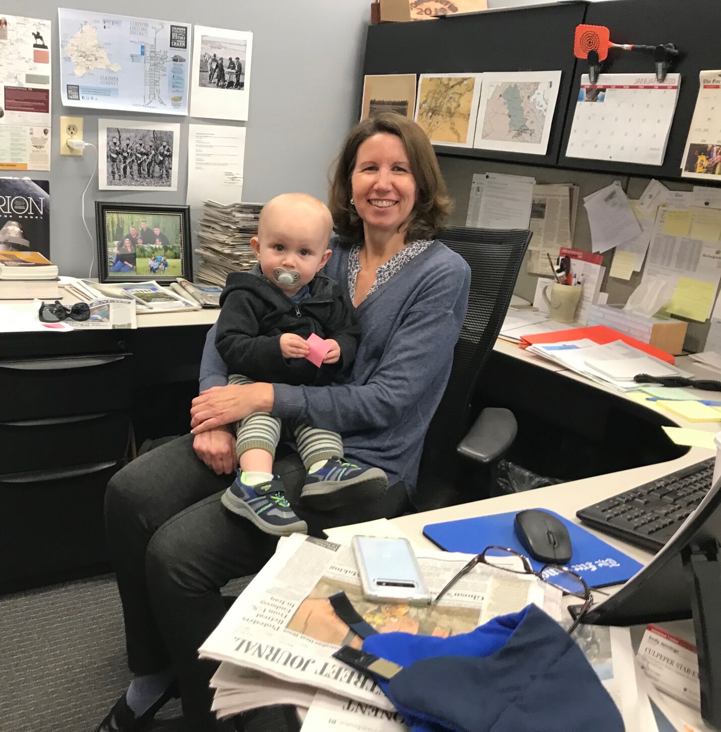 Emily Oaks with her grandson in the Culpeper Star-Exponent newsroom. She resigned as editor last summer.