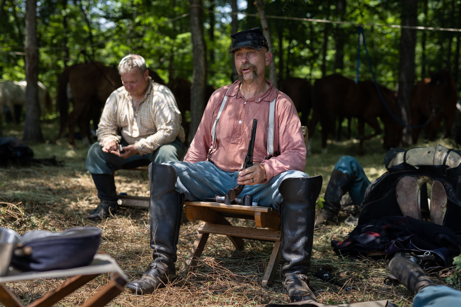 Paul Graves of Michigan, representing the 8th Illinois Cavalry, reloads his revolver, a .44-caliber cap-and-ball Colt.