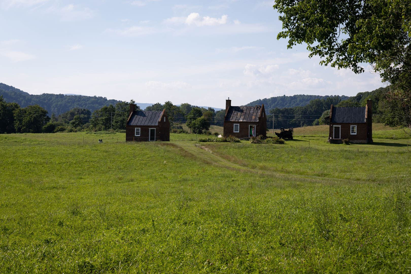 The three slave cabins referenced on the Twilight of Slavery: "Enlightened" Accommodations No Match for Freedom marker.