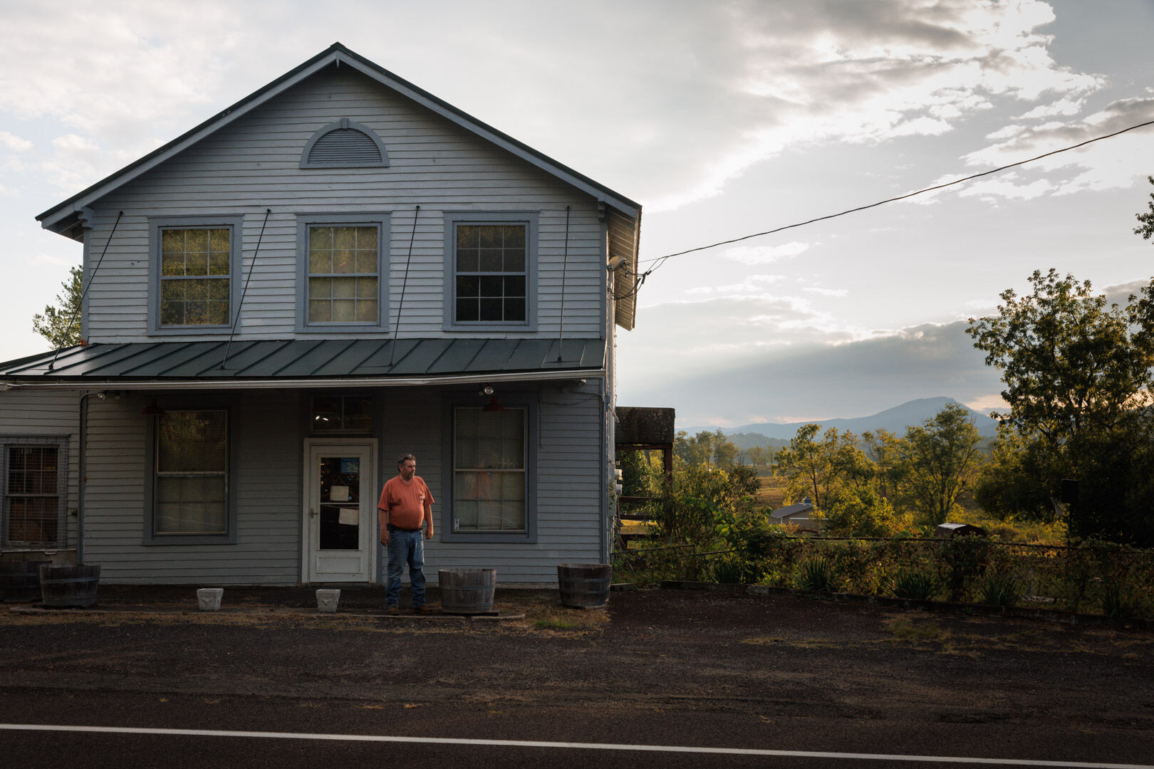 Richie Burke out front of his family’s antiques store, with Old Rag Mountain in the background.