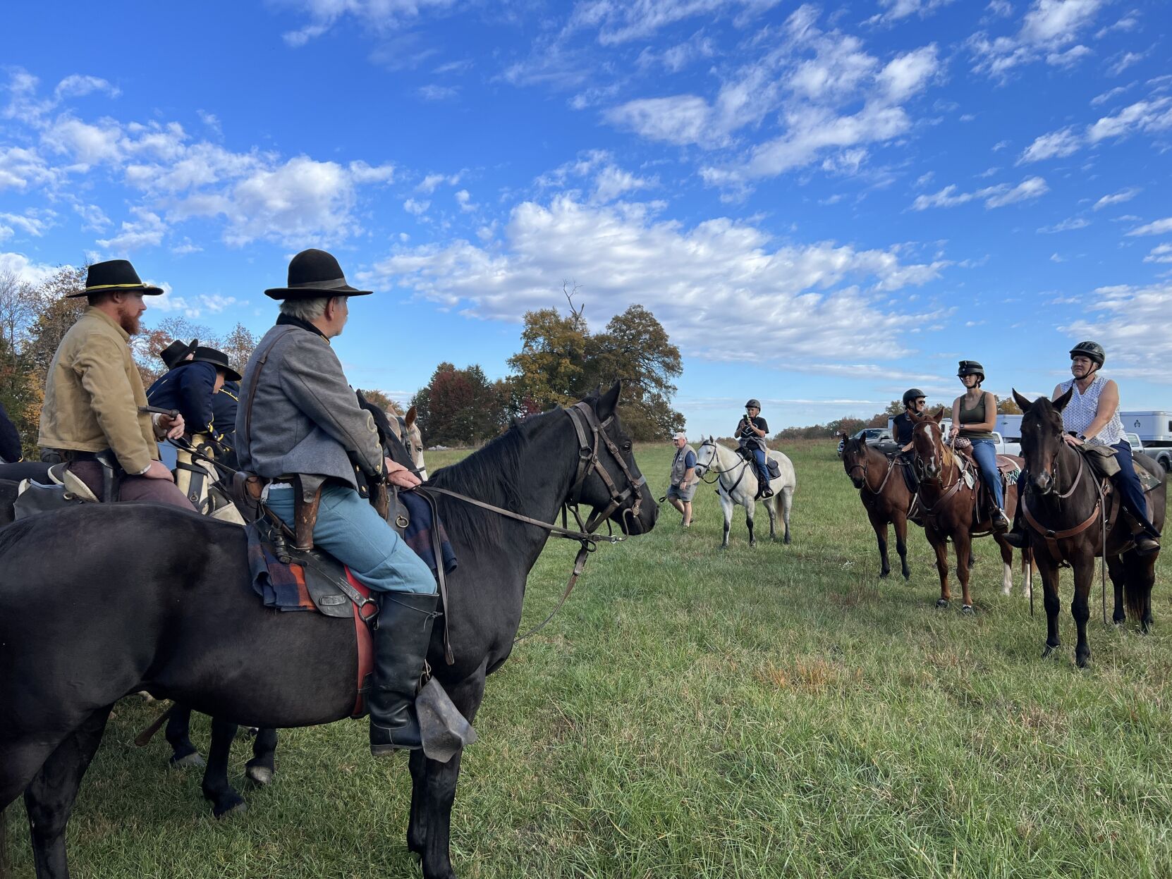 Civil War cavalry reenactors greet Virginia Horse Council riders Saturday as they begin a history trail ride of the Brandy Station battlefield.