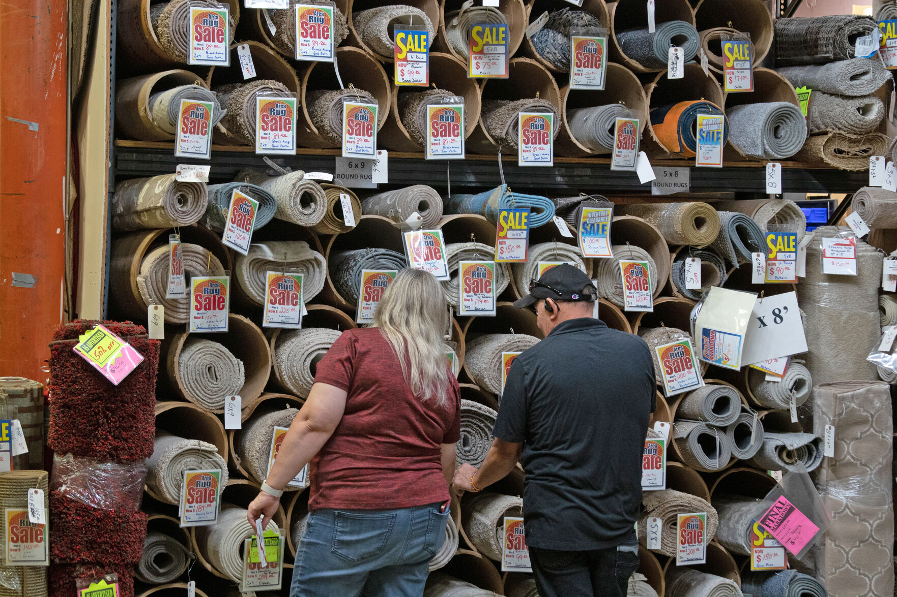 Guests browse rugs in the Early's Carpet warehouse, where the Amissville business hosted an open house and ribbon-cutting celebrating their newest addition on Friday.
