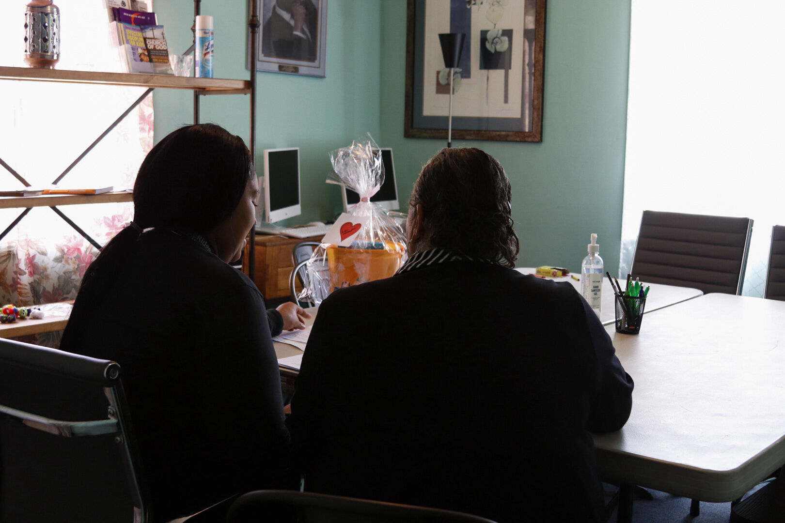 Community Touch Housing Locator Angela Robinson helps a young mother fill out paperwork to help secure housing for herself and her small children at the organization’s office in Warrenton, which doubles as a transitional home.