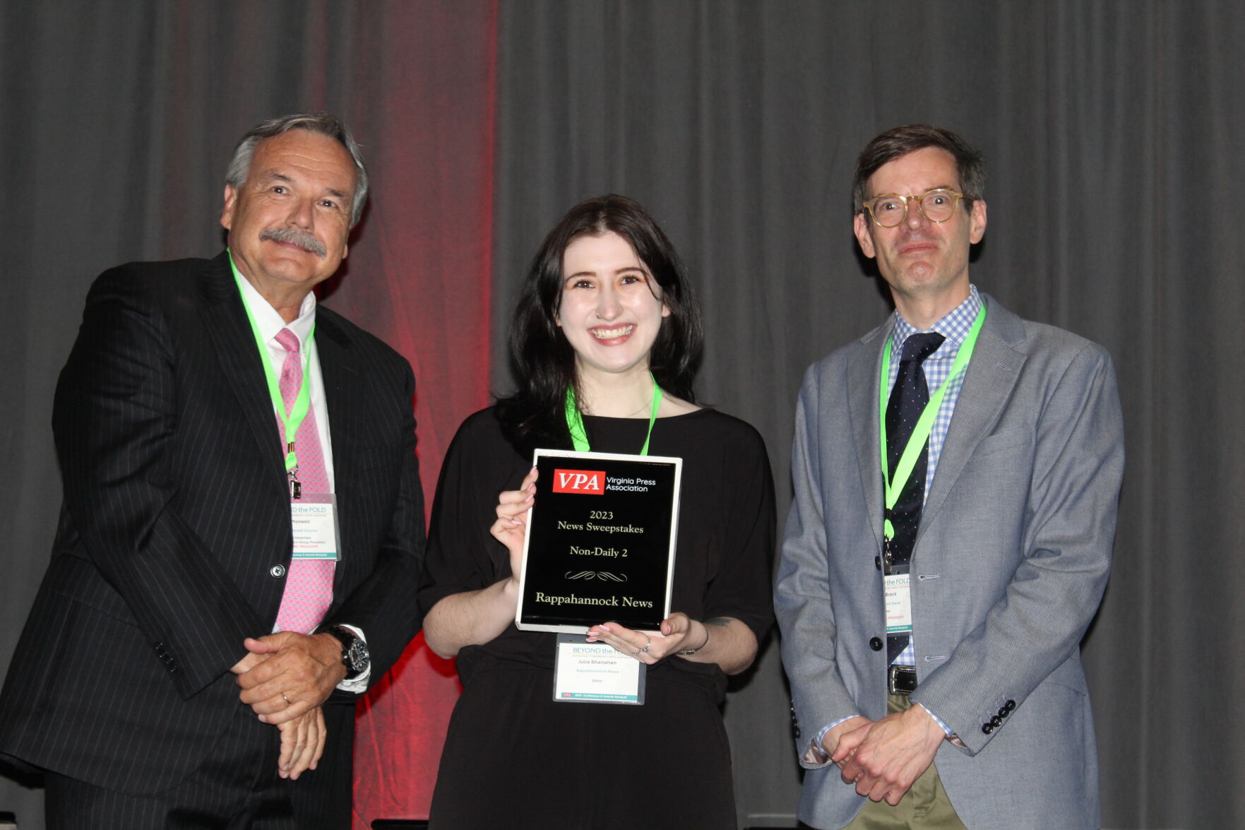 Virginia Press Association President Jim Maxwell and Dennis Brack, VPA vice president and publisher of the Rappahannock News, present the News Sweepstakes award to Rapp News Editor Julia Shanahan during Saturday evening's award ceremony in Charlottesville.