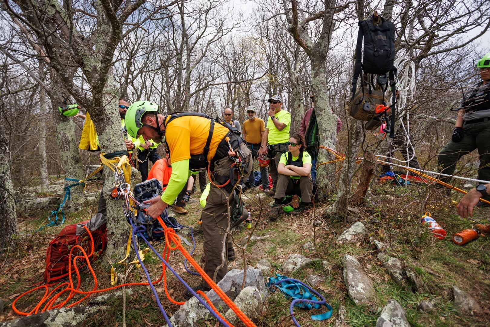 Moses adjusts the pulley and ropes used to lower a litter with a 150-lb. dummy down the cliff.