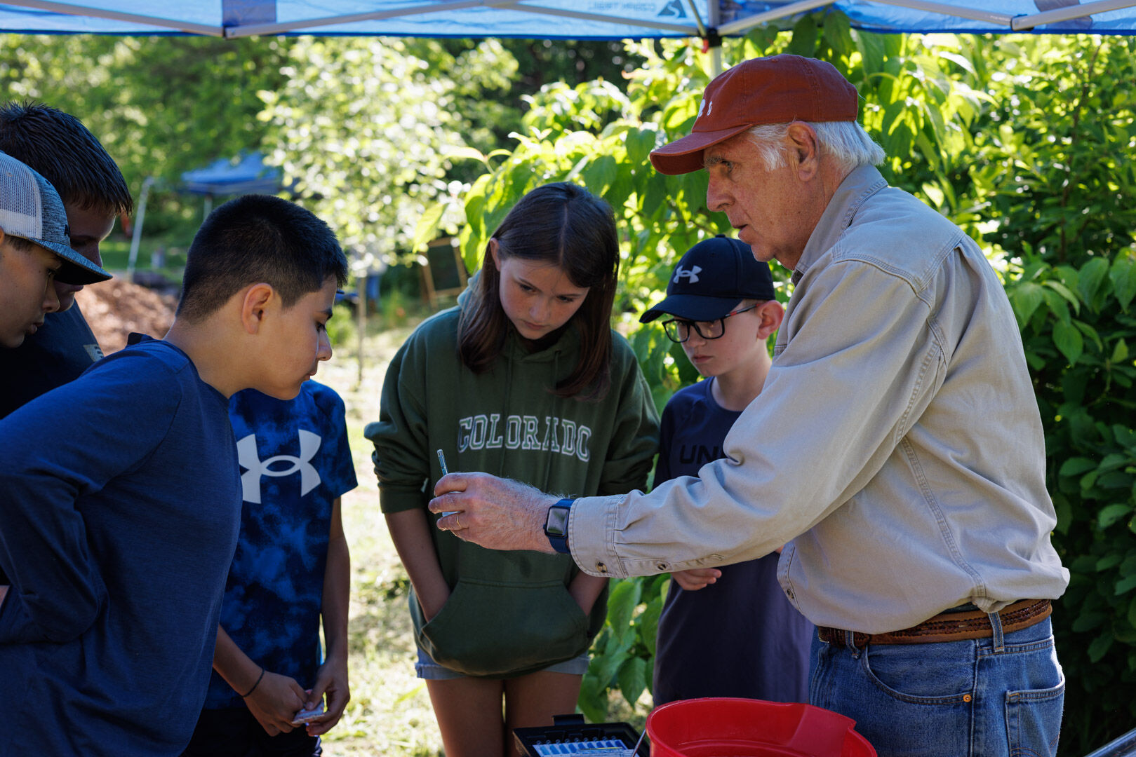 Bob Hurley tests water samples with Rappahannock County Elementary students at the Chemical Water Testing station.