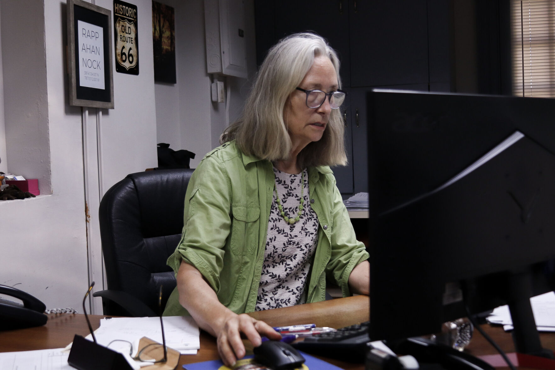Mary Graham working in her office in the Town of Washington. She has served as Commissioner of the Revenue since 2019.