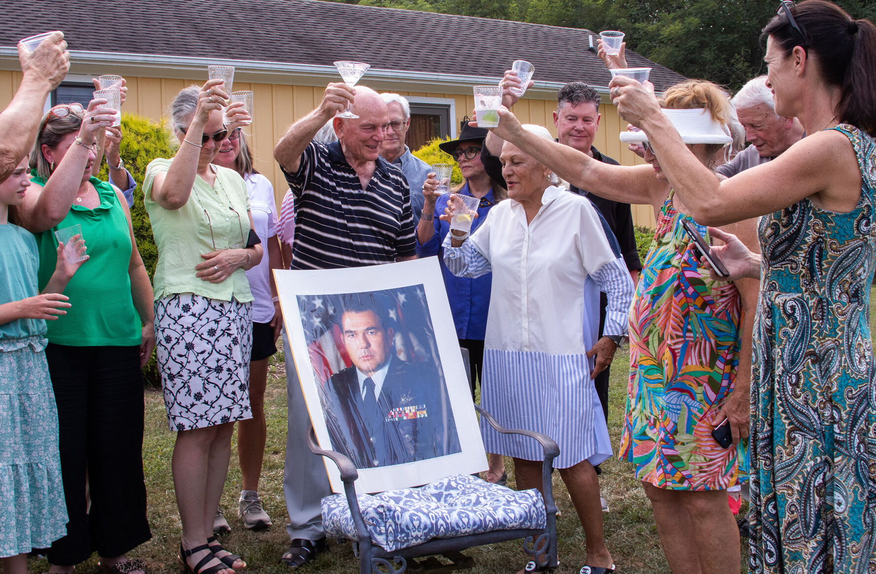 The group raises a toast to Hughes as the planes fly overhead.
