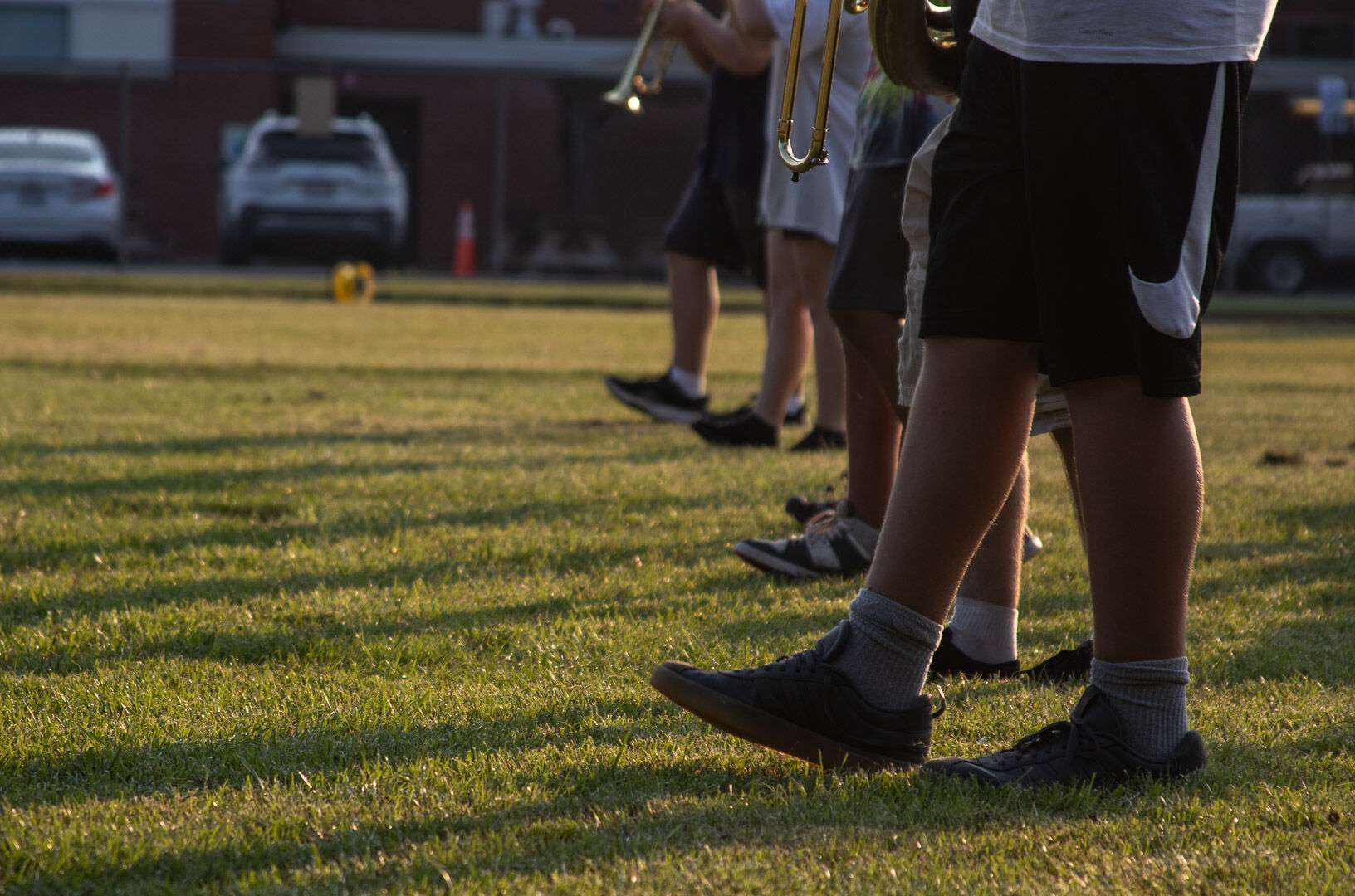 The brass line steps off, moving to the next formation. (Photo/Ireland Hayes for Foothills Forum)