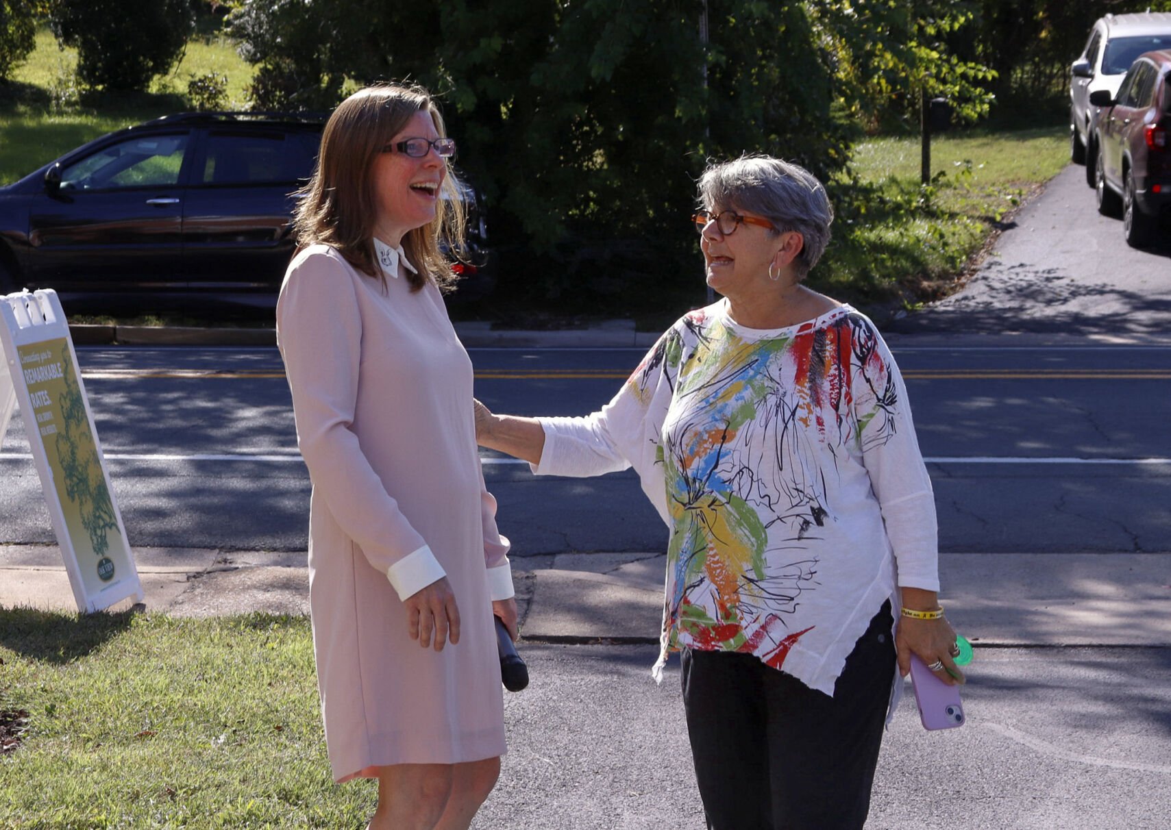 Businesses of Rappahannock President Laurie Smith and Jan Makela chat on the front lawn Oak View's new Flint Hill branch.
