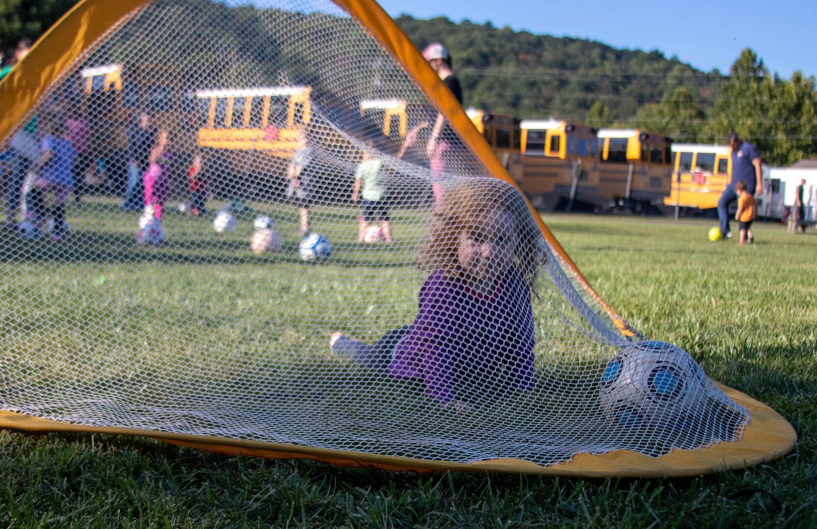 A U4 player hanging out in the goal at practice Friday night. (Photo/Ireland Hayes for Foothills Forum)