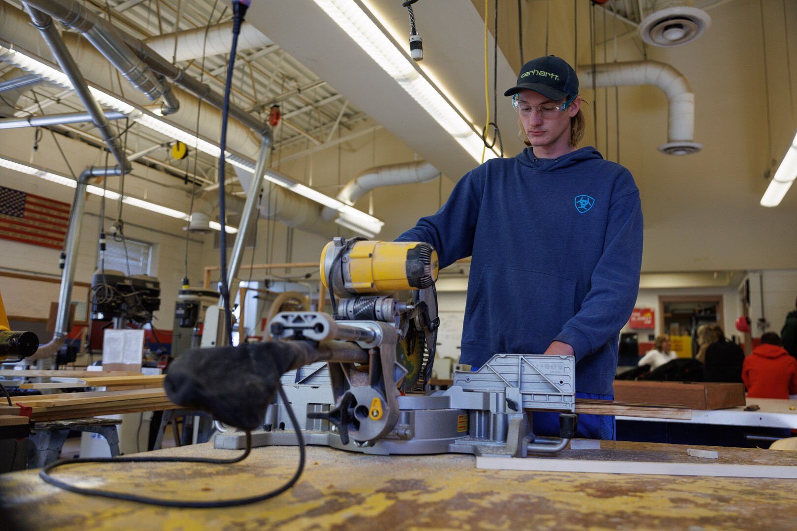 Scott Woodward, a senior at RCHS works on a custom cedar inlay for the stairs on shed the students are building for auction ay the building trades classroom.