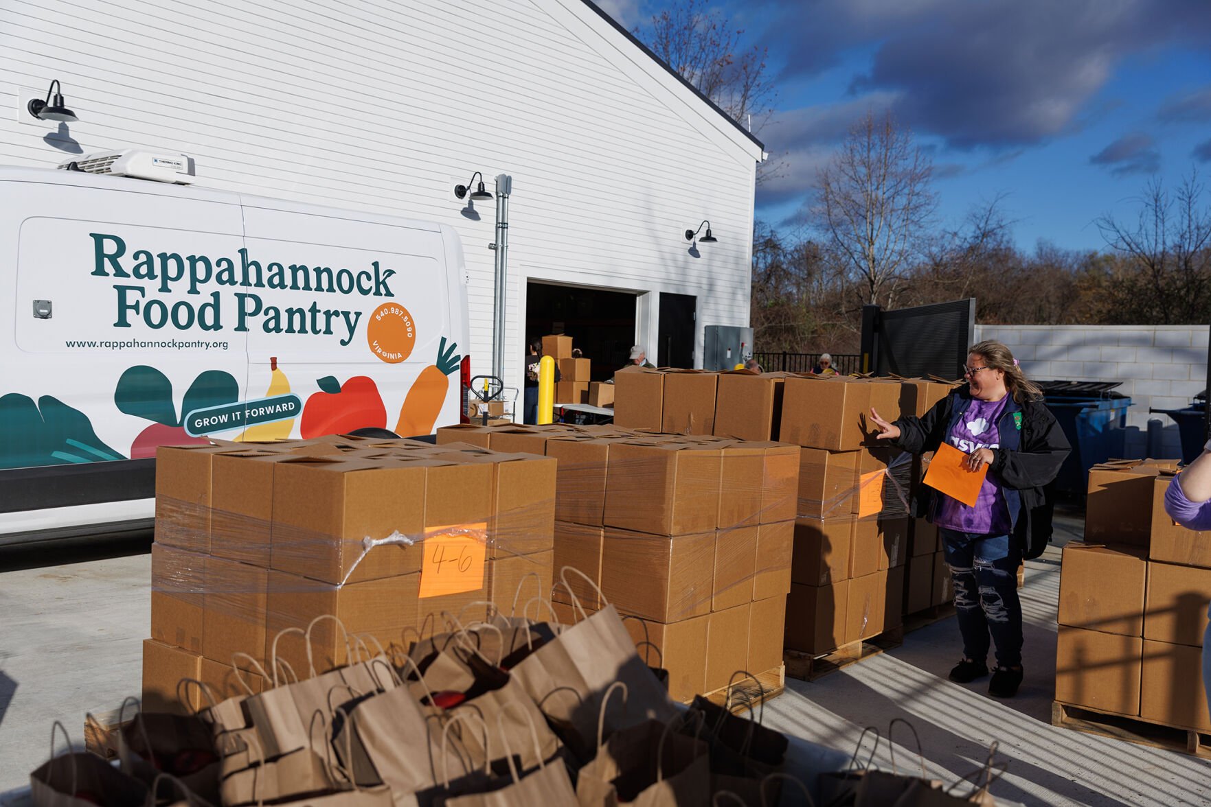 Volunteer Sharon Ennis helps tally up the over 250 boxes of dry goods and produce for Thanksgiving.