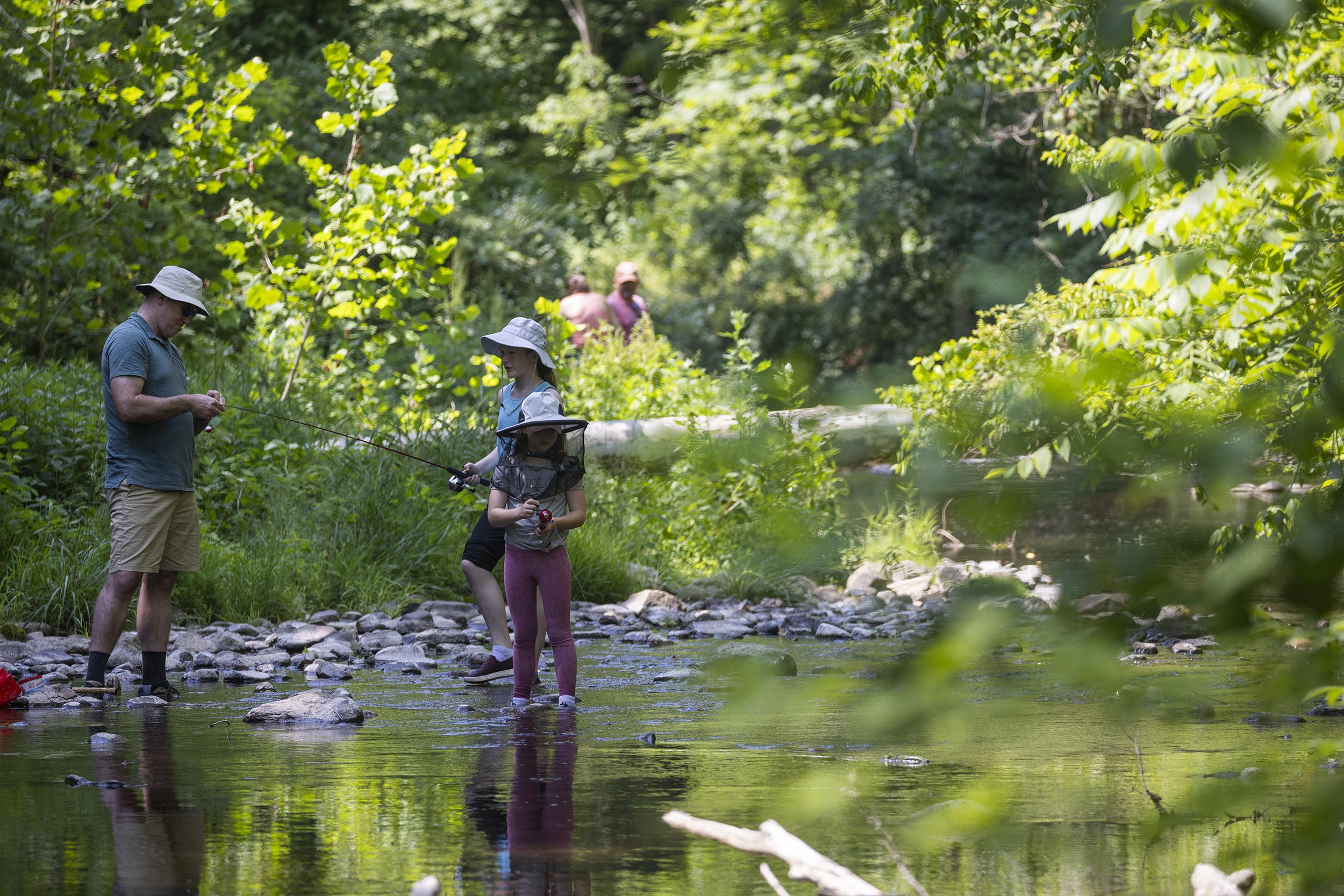 A family trout fishing at the county park.