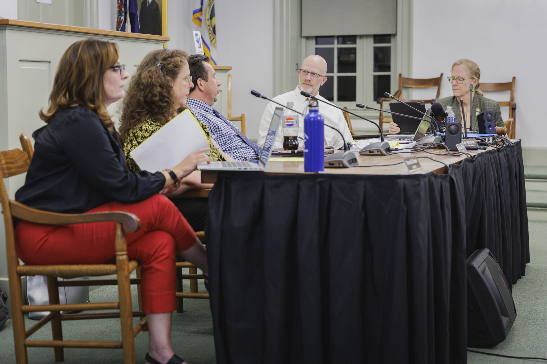 The Board of Supervisors members and Garrey Curry sitting at a table speaking in the courthouse at a meeting.