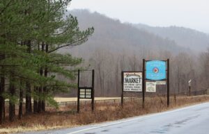 two signs identifying both Hearthstone school and the Rainbow Market near Route 211 in sperryville.