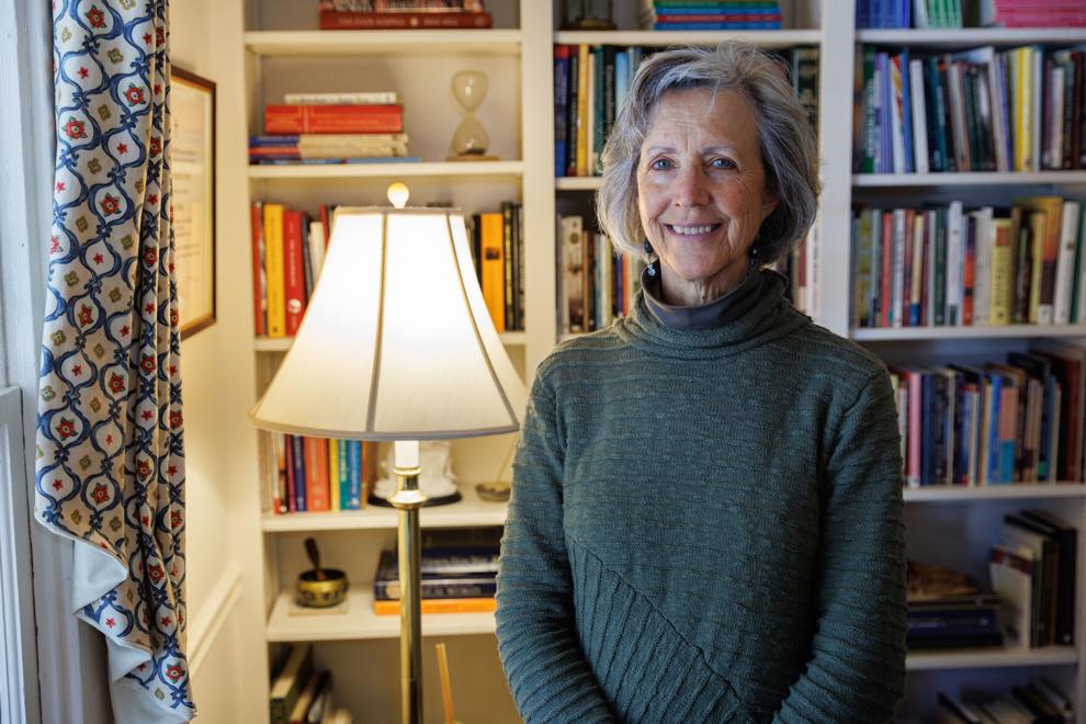 Berni Olson in her office in front of a bookshelf posing for a photo.