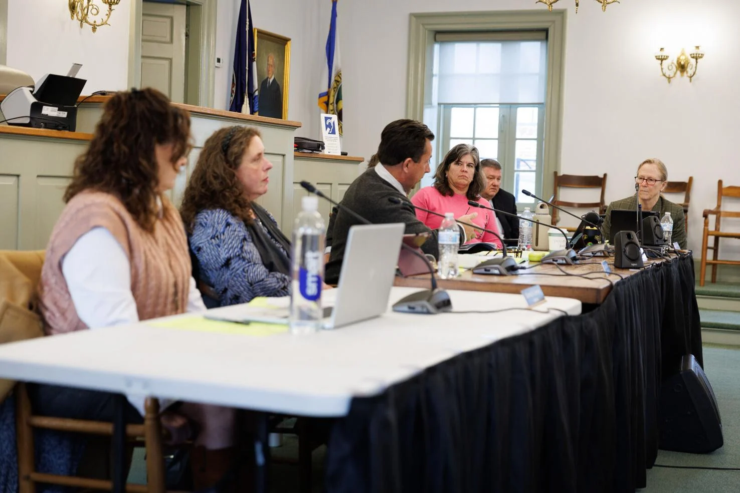 Bonnie Jewell sitting at a table with the board of supervisors at their meeting