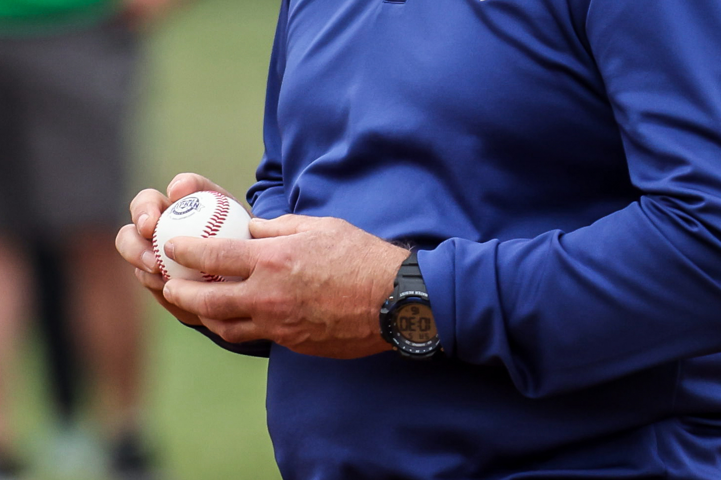 hands holding a white baseball