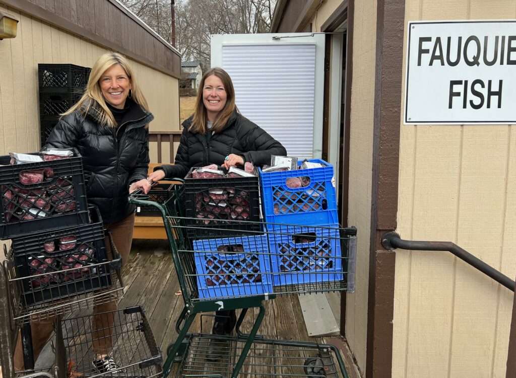 F.T. Valley Farm owner Kathy Penkiunas, left, and market manager/director of sales and distribution Meredith Gilmore donate goods from the farm to Fauquier Fish, a nonprofit organization in Warrenton.