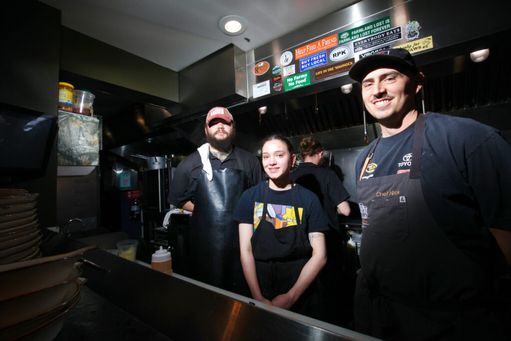 Johnny Beard, Ceal Brooks and Nick Puletti of New Iberia Kitchen prepare orders for their customers at The Marketplace Sperryville.