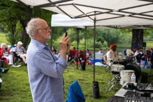 Reisler takes a photo while working as the sound engineer for retired Marine Col. John R. Bourgeois' Fourth of July concert at Avon Hall in July of 2023.